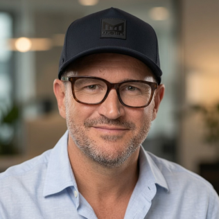 Headshot of Richard Jones smiling with glasses and a black cap